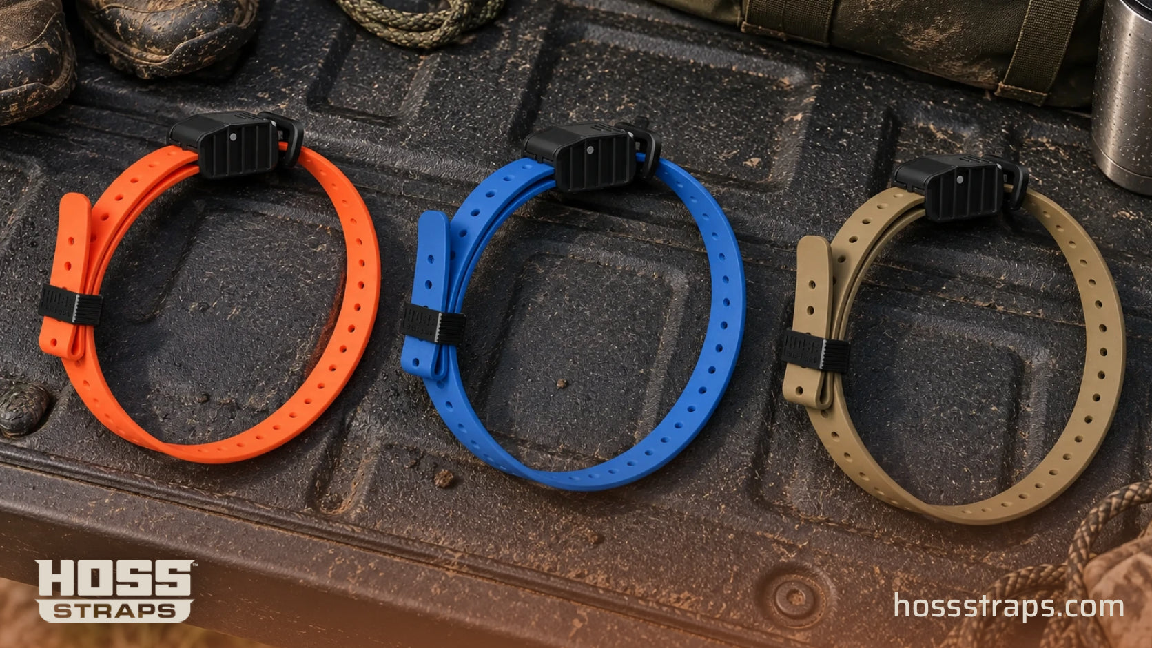 Orange, blue and tan HOSS e-collar kits organized on a truck tailgate